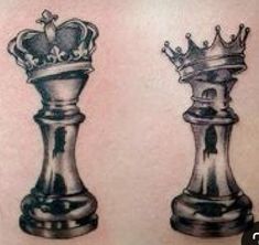 two silver chess pieces with crowns on them