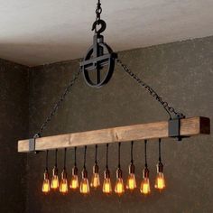 a chandelier with six light bulbs hanging from it's chain and wooden beam