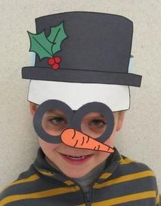 a young boy wearing a top hat and holding a carrot in front of his face