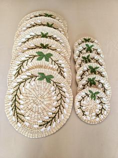 woven placemats with green leaves on them