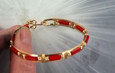 "ELEGANT HIGH FASHION RED CORAL   GEMSTONE BANGLE BRACELET  IN 14KT ROLLD GOLD  HANDCRAFTED IN 14KT ROLLED GOLD A UNIQUELY DESIGNED BRACELET UNIQUE HANDCRAFTED PIECE THAT WILL GET YOU NOTICED! LIGHTWEIGHT AND EASY TO WEAR SIZE ----- SIZE 6 TO 8 BRACELET IS  A HALF INCH WIDE  IT IS COMFORTABLE HEAVY DUTY HOOK AND CATCH MAKES IT EASY TO TAKE ON AND OFF AN EYE CATCHING PIECE! WEAR IT CASUAL OR FORMAL OUR GEMSTONES ARE AAA HIGH GRADE   7 THINGS TO KNOW ABOUT 14KT ROLLED GOLD #1. 14 Kt Rolled gold wire is also called gold filled wire------This gold wire was used extensively in the 1800's and early 1900s. It is not used very much today its too expensive.  It is durable that is it is very, very strong and last a long long time. DO NOTCONFUSE IT WITH GOLD PLATE. It has 100 times more gold then gol Gold Red Coral Bracelet For Gift, Gold Red Coral Bracelets For Gifts, Handmade Adjustable Red Bangle, Elegant Handmade Red Bangle, Red Hand-strung Bangle Bracelet, Gemstone Bangle Bracelets, Sculpted Jewelry, Shiny Jewelry, Wire Wrapped Bangles