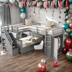 there is a loft bed with stairs in the room and balloons all over the floor