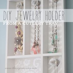 a jewelry holder with several necklaces hanging from it's sides and the words diy jewelry holder from a nursery tray