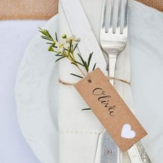 a white plate topped with a fork and knife next to a tag that says love