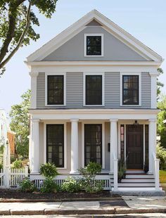 a white house with black shutters on the front