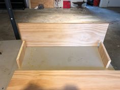 two unfinished wooden boxes sitting in a garage