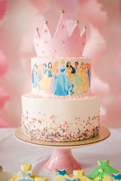 there is a cake decorated with princesses on it