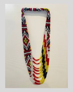 This hand-made T'boli necklace features a layered black, white, red, and yellow bead pattern. This product is made by the T'boli women weavers of Lake Sebu, South Cotabato, Philippines. The T'boli People are known for their colorful ornaments, regal attire, and their unique t'nalak weaving that makes use of abaca and natural dyes. Traditional Handwoven White Beads, Traditional Handwoven Black Necklace, Traditional White Handwoven Beads, Traditional Black Handwoven Necklace, Traditional Multicolor Multi-strand Beads, Artisan Black Beaded Necklace Handwoven, Artisan Handwoven Black Beaded Necklace, Artisan Black Handwoven Beaded Necklace, Traditional White Fair Trade Necklaces