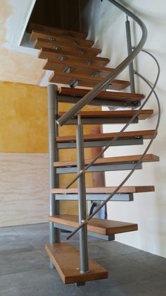 a metal and wood staircase in an empty room