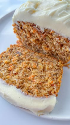 a piece of carrot cake with white frosting on a plate