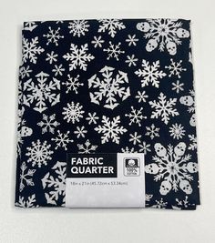 the fabric is black with white snowflakes on it