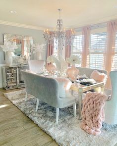 a dining room table with chairs and a chandelier