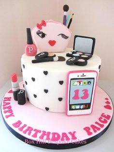 a birthday cake with makeup, lipstick and cell phone on the top is decorated in pink and black