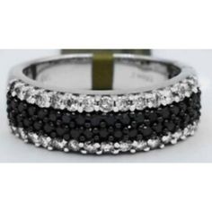 Karat: 14k White Gold Gem Type: 34 Genuine Black Diamonds 30 Genuine White Diamond- 0.02 Ct Each Total Ct Weight: 1.28 Carats White Diamond Grades, Clarity Grade...Vs1 Color Grade...H1 Cut...Very Good Net Weight: 5.6 Grams Type Of Setting: Shared Prong Shape Of Diamonds: Round Dimensions: 6.5 Mm Wide Black Diamond Ring With Vvs Clarity In 14k Gold, Black Diamond Jewelry With Polished Finish, Black Diamond Ring With Vvs Clarity And Round Shape, Luxury Black Diamond Sterling Silver Ring, Black White Diamond Ring, Black Sterling Silver Diamond Ring, Fine Jewelry, White Diamond Ring, Diamonds And Gold, Black Diamond