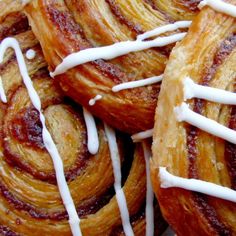 closeup of cinnamon rolls with icing drizzled on them