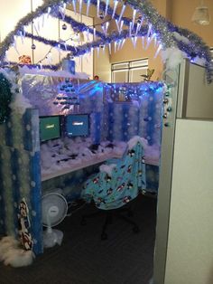 an office decorated for christmas with blue and white decorations