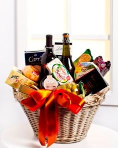 a wicker basket filled with wine and snacks