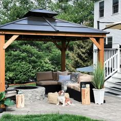 an outdoor living area with couches and a gazebo