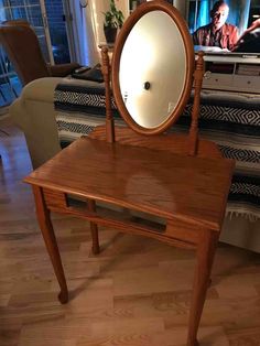 a mirror sitting on top of a wooden table