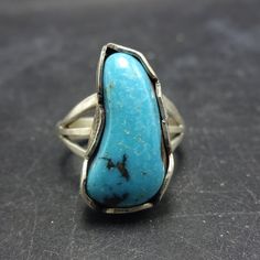 VINTAGE TURQUOISE RING DESCRIPTION:  This fabulous ring features a gorgeous specimen of blue turquoise set in hand stamped scalloped bezel, held by a split shank band. This ring will be a cherished addition to your collection of quality vintage Southwestern and Native American jewelry. MEASUREMENTS:  Ring face measures 3/4" x 3/8" RING SIZE: 7 WEIGHT:  5.4 grams SIGNED:  no STERLING:  unmarked, verified sterling silver Vintage Turquoise Ring, Jewelry Measurements, Silver Turquoise Ring, Sterling Silver Rings Turquoise, Cowgirl Jewelry, Turquoise Ring Silver, Ring Pictures, Split Shank, Vintage Turquoise