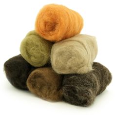 a pile of wool balls sitting on top of each other in front of a white background