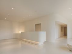 an empty room with white walls and lights on the ceiling is pictured in this image