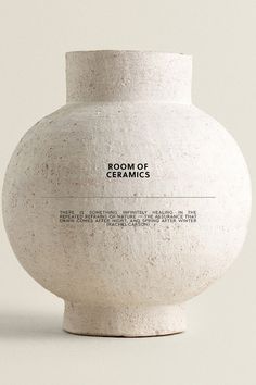 a white vase sitting on top of a table