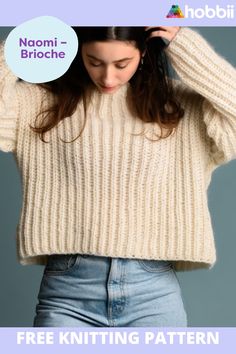 a woman wearing a white knitted sweater with the words free knitting pattern on it