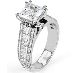 a princess cut diamond ring with channeled sidestones on the band and shoulders, set in white gold