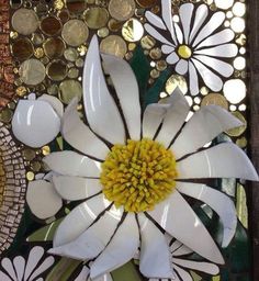 a white flower sitting on top of a green plate next to a bowl filled with coins