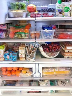 an open refrigerator filled with lots of different types of fruits and vegetables in it's shelves