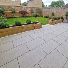 an outdoor patio with raised planters and landscaping