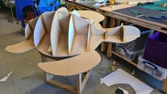 a chair made out of cardboard sitting on top of a table