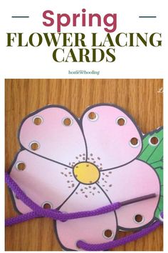 a pink flower with green leaves on it and the words spring flower lacing cards