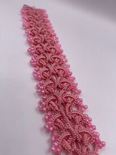 pink beaded lace on white background