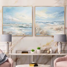 two paintings on the wall in a living room with pink chairs and a coffee table