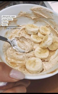 a person holding a spoon in a bowl of peanut butter and banana slices with text above it