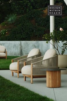 modern outdoor lounge chairs from design within reach on outdoor patio surrounded by green grass and flowers