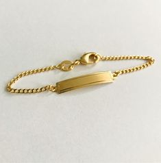 "18K GOLD FILLED BABY ID BRACELET...5.5\" Long FREE GOLDEN GIFT POUCH INCLUDED 18K BANO DE ORO PULSERA CON PLACA PARA BEBE . 5.5\"LONG BOLSA DE REGALO GRATIS" Classic Gold Name Bracelet Hypoallergenic, Classic Gold Hypoallergenic Name Bracelet, Classic 14k Gold Hypoallergenic Name Bracelet, Classic Hypoallergenic 14k Gold Name Bracelet, Gold Rectangular Name Bracelets, Rectangular Gold Name Bracelets, Classic Gold Name Bracelet, Hypoallergenic Gold Nameplate Jewelry, Gold Rectangular Name Bracelet, Tarnish Resistant