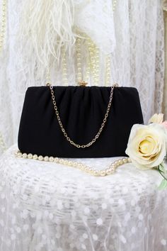 Beautiful vintage small black clutch purse with a small gold chain handle..very simple and elegant. Great vintage condition. Pre Loved Great Vintage Condition No Stains, Rips, Holes or Fade Note: Clean interior and exterior. Vintage Possibly 60s 70s Brand: Unknown Classic Small Black Clutch Purse Small top gold chain..(Wrist Clutch Purse) Gold metal frame Note: Gold sparkly clasp snap mechanism that closes perfect. The outer of purse is made of polyester fabric, that can be easily cleaned. No in Classic Evening Bag With Chain Strap For Parties, Classic Chain Strap Evening Bag For Parties, Classic Party Evening Bag With Chain Strap, Black Formal Clutch With Chain, Formal Black Clutch With Chain, Black Chain Clutch For Formal Occasions, Elegant Black Clutch With Chain, Elegant Evening Bag With Gold Chain, Elegant Evening Bag With Gold Chain For Formal Occasions