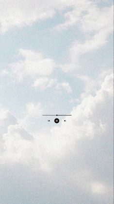 an airplane is flying in the sky on a cloudy day