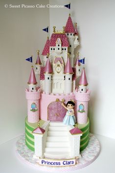 a princess castle cake is shown on a white tablecloth with pink and green trim