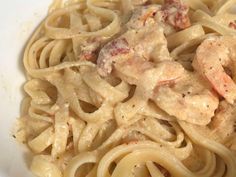 pasta with shrimp and cream sauce in a white bowl