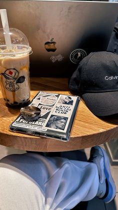 a wooden tray topped with a laptop computer next to a drink