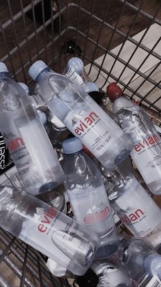 a shopping cart filled with bottled water bottles