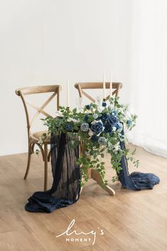 two chairs with flowers and greenery on them