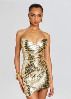 Turn heads, command attention, and make a lasting impression with our Aura Dress. This mini dress is a true masterpiece, featuring a flattering bodycon fit, a strapless bustier top for a touch of allure, and an asymmetrical hem that adds a hint of drama. Shown here in Gold. HANDMADE Rhinestone hotfix 100% Polyester Mad Gold Hoco Dress, Rhinestone Hotfix, Fiesta Outfit, Bachelorette Party Bride, Strapless Bustier, Rehearsal Dress, Pretty Lingerie, Reception Dress, Metallic Dress