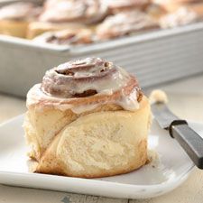 cinnamon rolls on a plate next to a baking pan