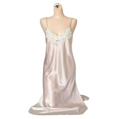 Step into the boudoir of elegance with this satin slip dress. It's like wearing a cloud, but sexier. Perfect for those nights when you want to feel like a queen, or just impress your cat. * Made from luxurious satin & lace * Spaghetti straps for delicate support * Blush pink color with lace detailing that includes sequins and beads * Split, curved hem Bust (flat): 16 inches pit to pit Waist (flat):16 inches  Hip (flat): 17 inches Length: 42 inches Armhole opening (flat): 5 inches Shoulder to shoulder: 10 inches Excellent condition Slip Dress Lingerie, Lingerie Nightgown, Vintage Slip Dress, Dress Lingerie, Vintage Nightgown, Satin Slip, Satin Slip Dress, Beaded Lace, Split Hem