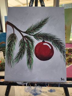 an acrylic painting of a red ornament hanging from a tree branch